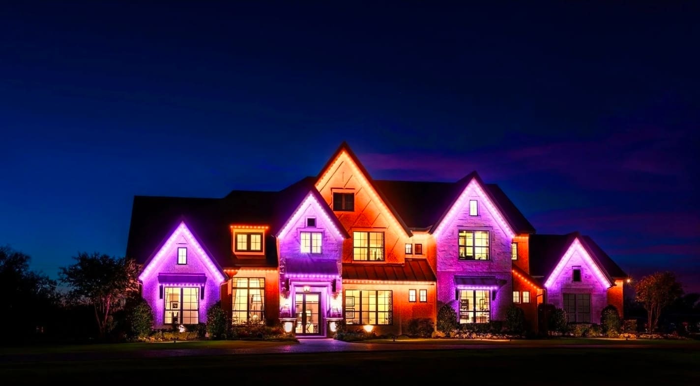 Holiday colored permanent LED lighting on home exterior showing vibrant color display
