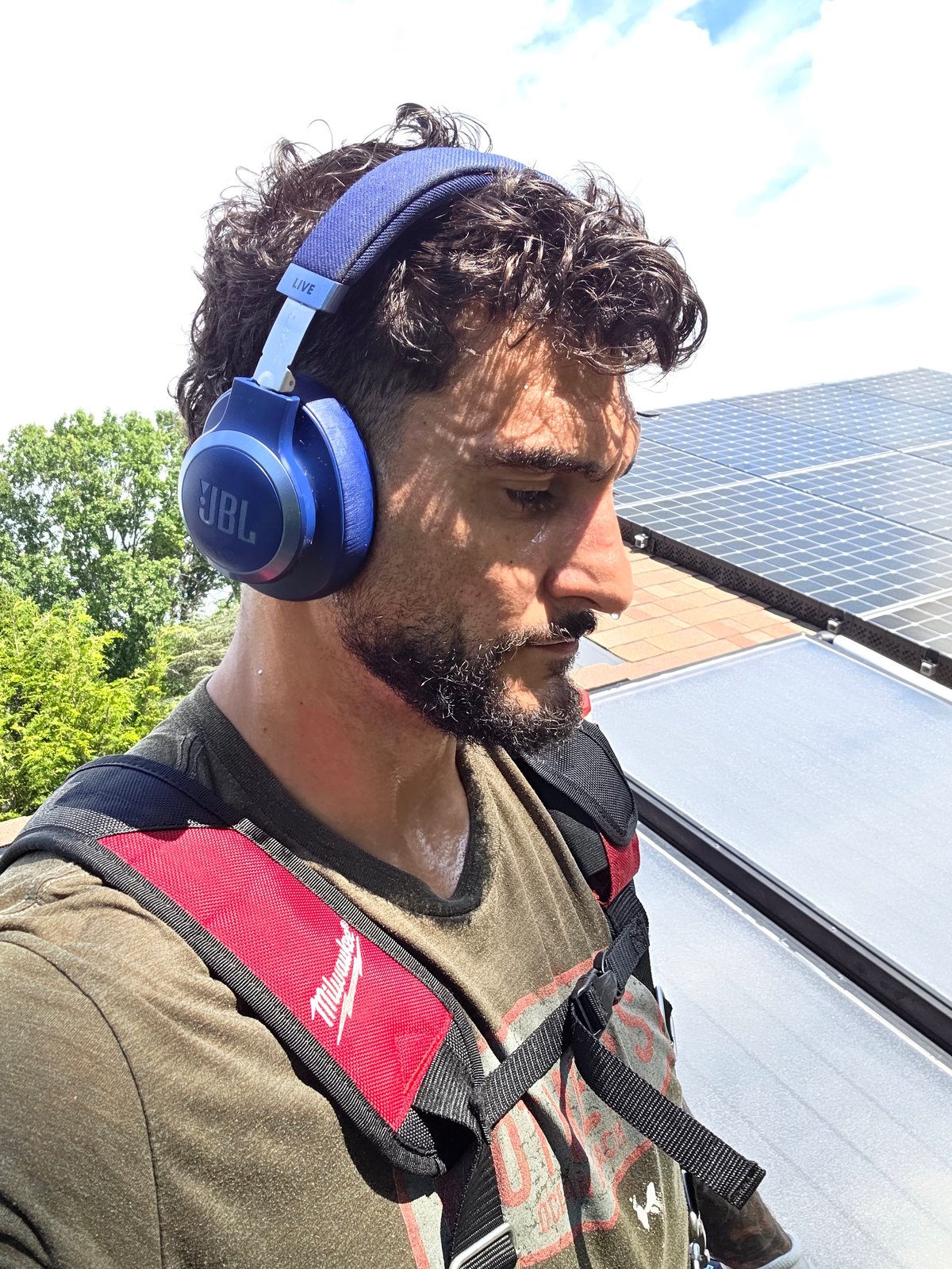 Alex, owner of CleanGutters Lighting, personally installing gutter protection on a local home