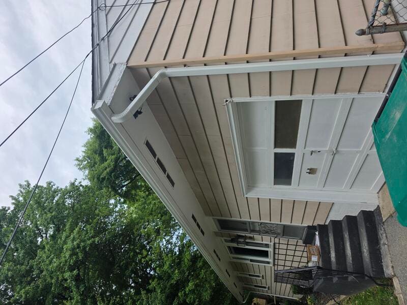 New downspout installed from gutter to ground on a garage