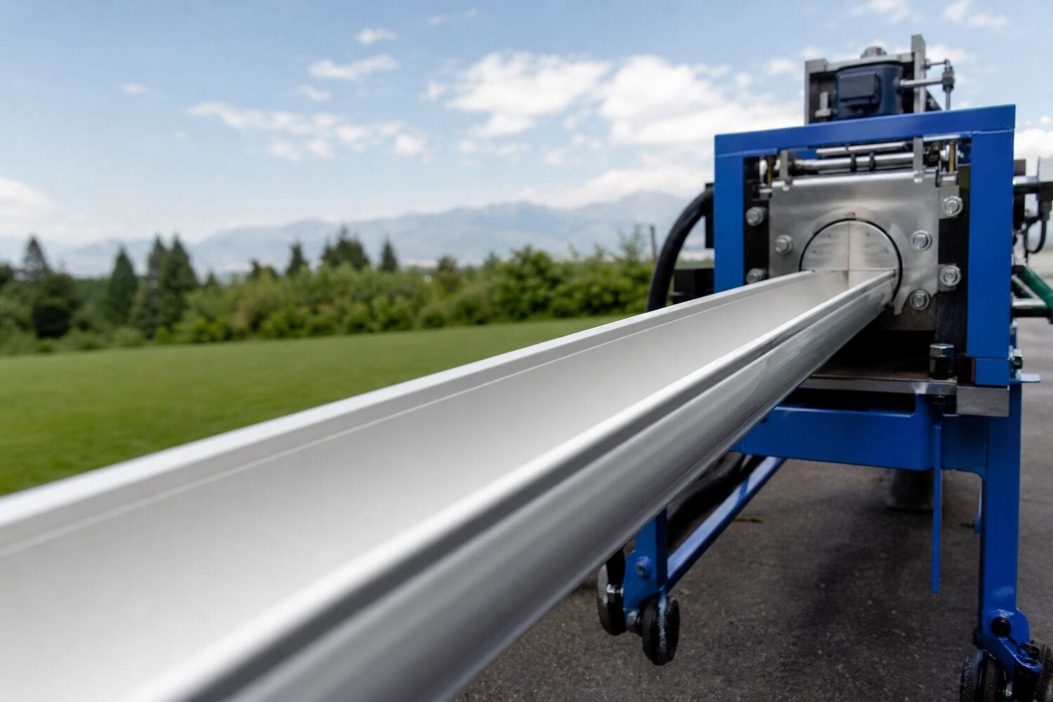 Seamless aluminum gutter being formed on-site by a gutter machine