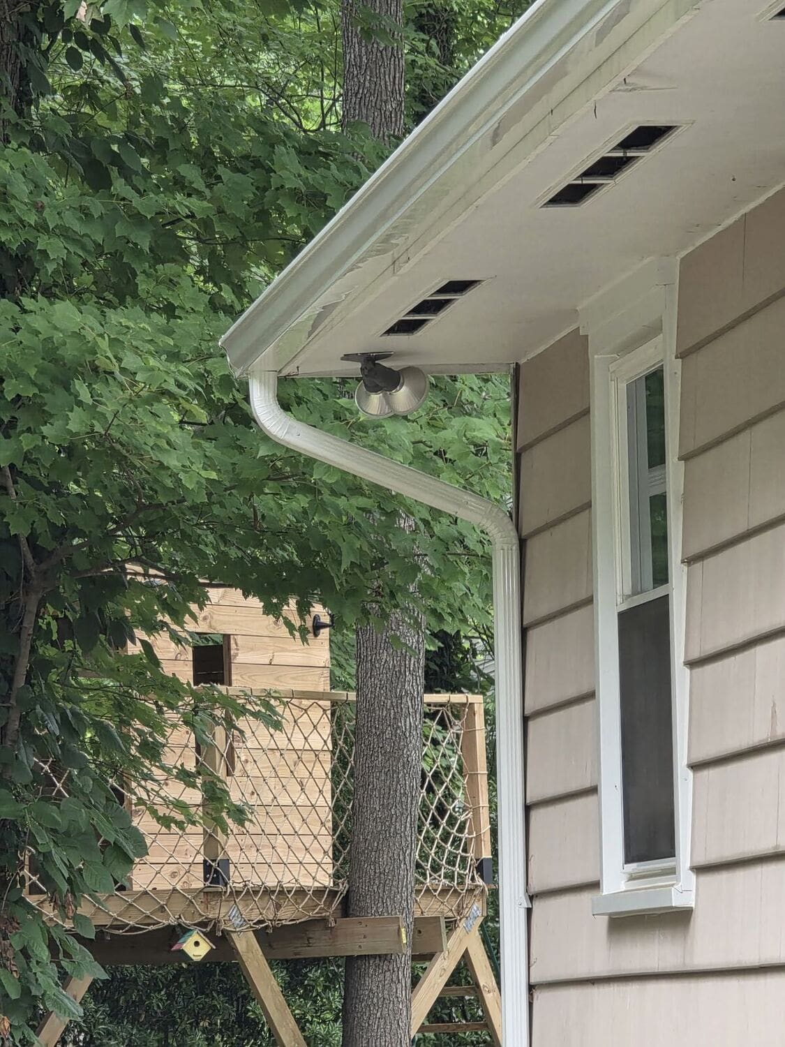 Fascia board detail behind newly installed gutters