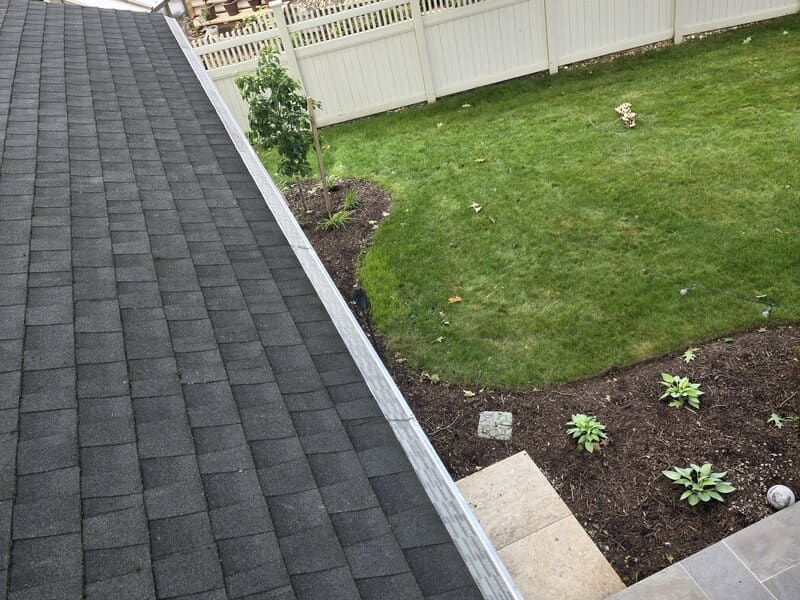 Full diagonal run of micro-mesh gutter guard installed over a backyard on a Cherry Hill home