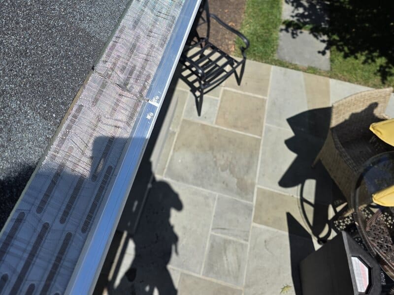 Stainless steel micro-mesh gutter guard installed along a South Jersey roofline by our crew