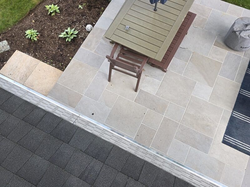 Finished gutter guard install above a stone patio in South Jersey